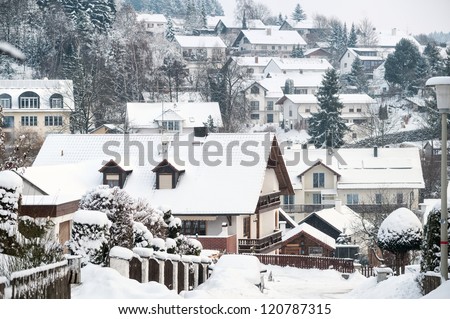 Snow covered village and traditional wooden houses in Germany