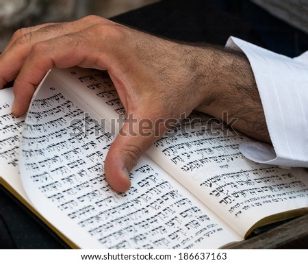 JERUSALEM, ISRAEL - AUGUST 22: Rabbi reading the Torah beneath the Western Wall on Bar Mitzvah celebration. Jerusalem, Israel, on August 22, 2013