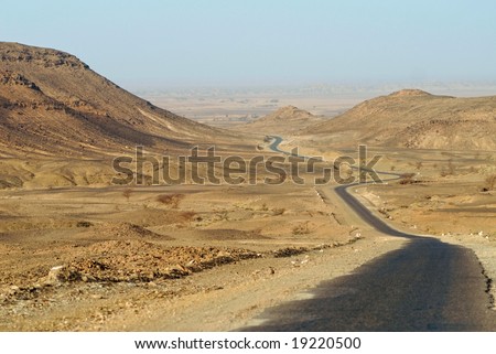 Desert asphalt road leading from Zagora in Morocco to M\'hamid on algerian border, North Africa
