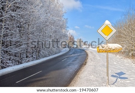 Winter snow-covered asphalt road and traffic sign in Germany, Europe