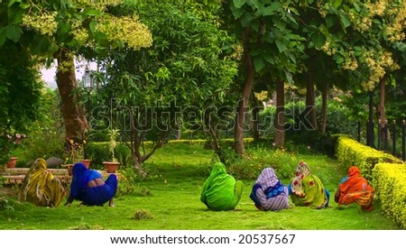 Indian women in colorful traditional saris working in the tropical garden near Bombay