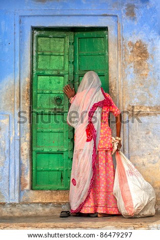 Indian woman knocking on the door