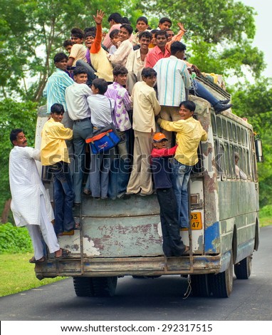 JHANSI, INDIA - AUGUST 19: Workers returning home at the evening in an overloaded bus in Jhansi province. Jhansi, India on August 19, 2013