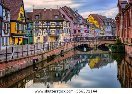 Colorful medieval half-timbered facades reflecting in water, Colmar, Alsace, France