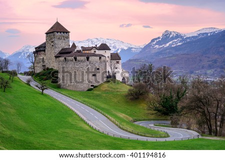 Vaduz Castle, the official residence of the Prince of Liechtenstein, with snow covered Alps mountains in background on sunset