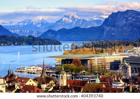 Lucerne old town and Culture center building on Lake Lucerne with snow covered Alps mountains in background