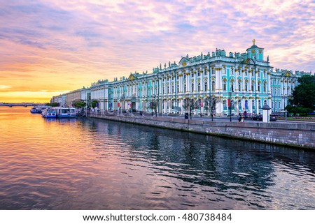 Winter Palace building housing Hermitage museum reflects in Neva river on dramatic sunrise, St Petersburg, Russia