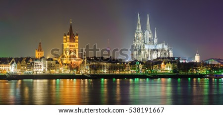Night panorama of Cologne, Germany, with Cologne Cathedral, Great St. Martin Church, Colonius TV Tower and main train station reflecting in Rhine river