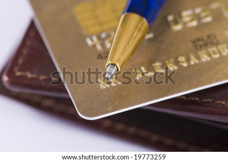 Credit card, wallet and ball-point pen in focus