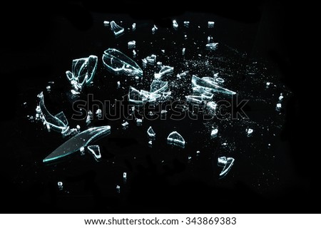 broken glass with sharp pieces over black background
