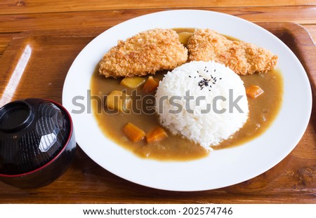 Japanese curry rice , fried fish curry on wooden tray