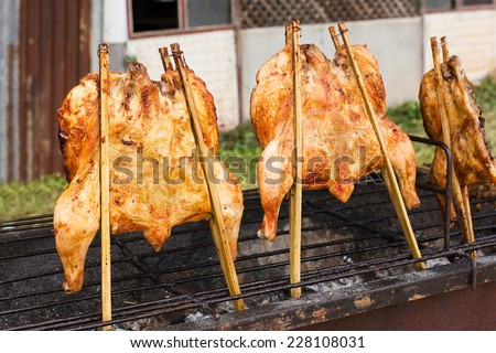 Chicken roast on grill. Local shop beside street in thailand.
