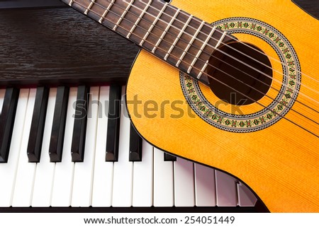 Piano key and guitar. Top view.