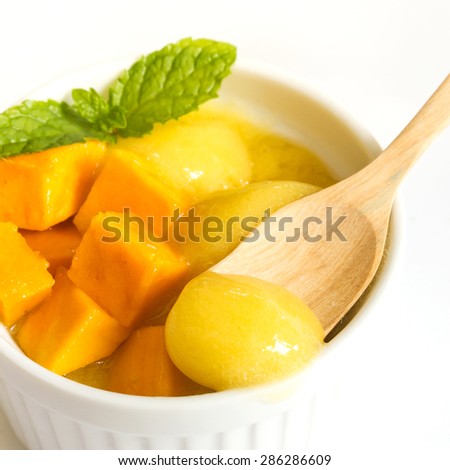 Closeup mango ice cream in a white bowl on white background.