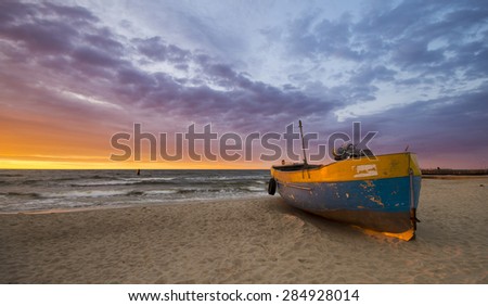 Fishing boats on the beach during a storm