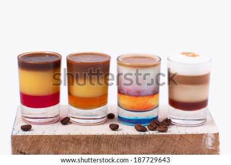 colorful coffee shots on wooden board on isolated white background with coffee beans