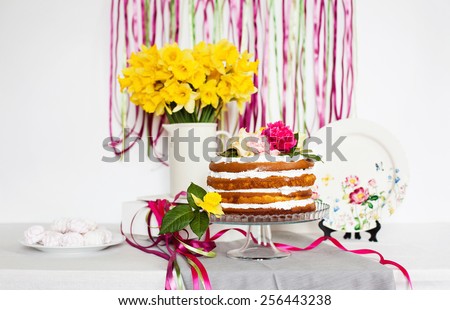 Dessert table decorated with cake pink ribbons and flowers