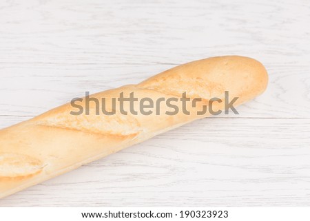baguette bread on white wooden background