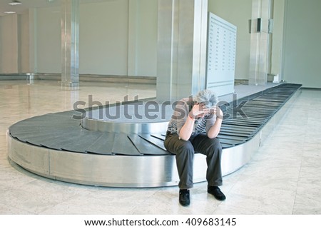frustrated woman lost luggage look upset sitting at the luggage carousel at an airport - concept of airline travelers troubles when luggage not arriving at destination with the flight -