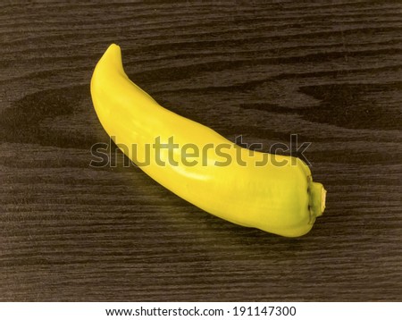 Fresh yellow banana pepper on wooden background
