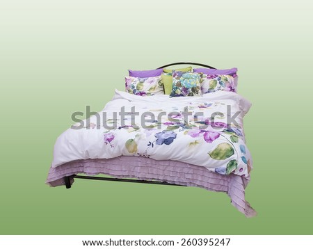 Bed with colorful duvet and cushions.Isolated on colorful background.