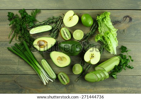 collection of green vegetables and fruits on wooden background