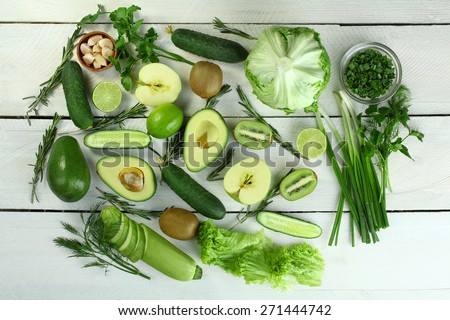 collection of green vegetables and fruits on wooden background