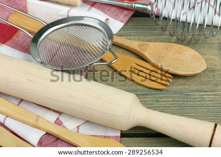 different wooden kitchen tools on the table with copy space