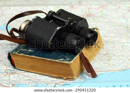 binocular with book at the topographic map background