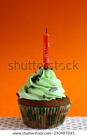 tasty cupcake on orange background. birthday