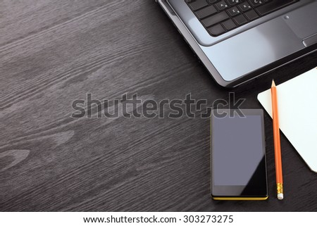 wooden, black background laptop, notebook, pencil, phone