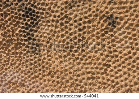 A pattern engraved in rock at close up. Suitable for backgrounds. Rock was found in a historic park dated around 3000 B.C.