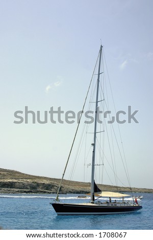 A medium sized yacht anchoured at a bay