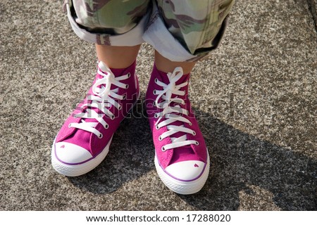 Young girl\'s feet with pink shoes and military capri\'s