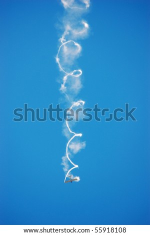 BRESLAU, ON, CANADA - JUNE 20: Its engine shut down, a small aircraft free-falls while releasing smoke from a wingtip at the Waterloo Aviation Expo and Air Show on June 20, 2010 in Breslau, Ontario.