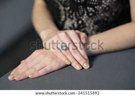 hands with a ring on the table