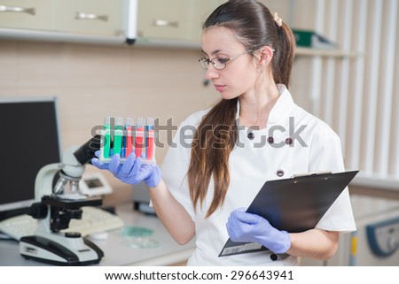 young prettyl woman scientist holding a test tube in a laboratory