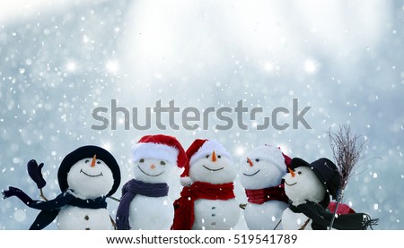 Merry Christmas and happy New Year greeting card with copy-space.Many snowmen standing in winter Christmas landscape.Winter background
