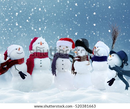 .Many snowmen standing in winter Christmas landscape.