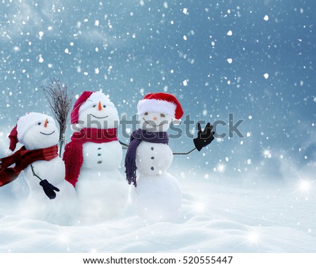 Merry Christmas and happy New Year greeting card with copy-space.Many snowmen standing in winter Christmas landscape.Winter background