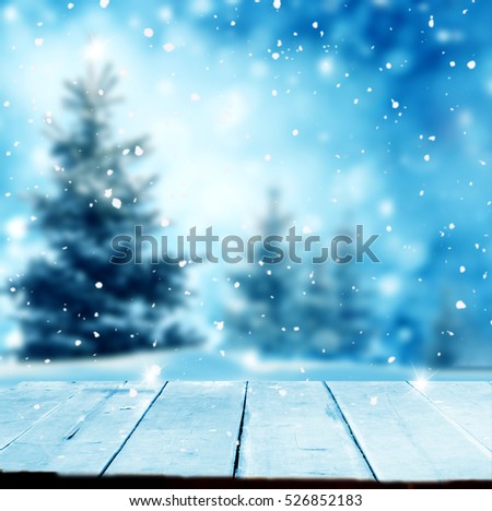 Merry Christmas and happy New Year greeting background with table .Winter landscape with snow and Christmas trees