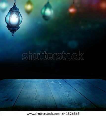 Ramadan Kareem background.Ramadan lantern and wooden  table