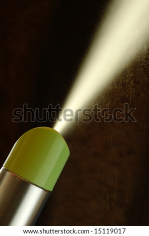 generic aerosol can spraying against dark background