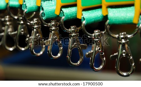 Row of safety hooks hanging on a green belts