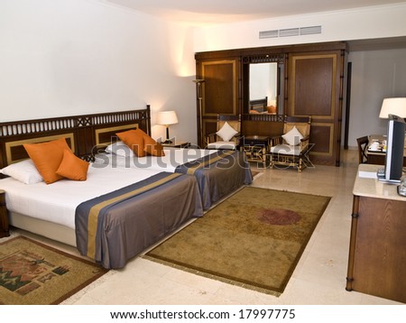 Sleeping room with two beds and TV-set