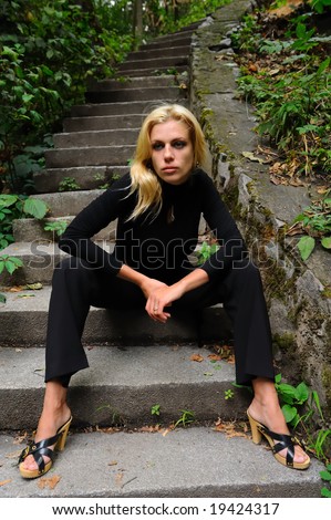 Sad blonde woman in black jersey