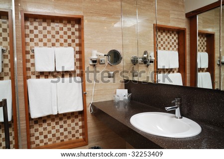 Towels and mirror on a wall of bathroom