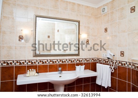 Lamp and mirror on a wall of bathroom