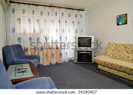 Modern furnished luxury living room. Photo in the frame made by the author