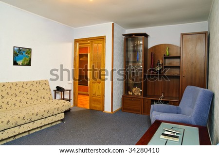 Modern furnished luxury living room. Photo in the frame made by the author